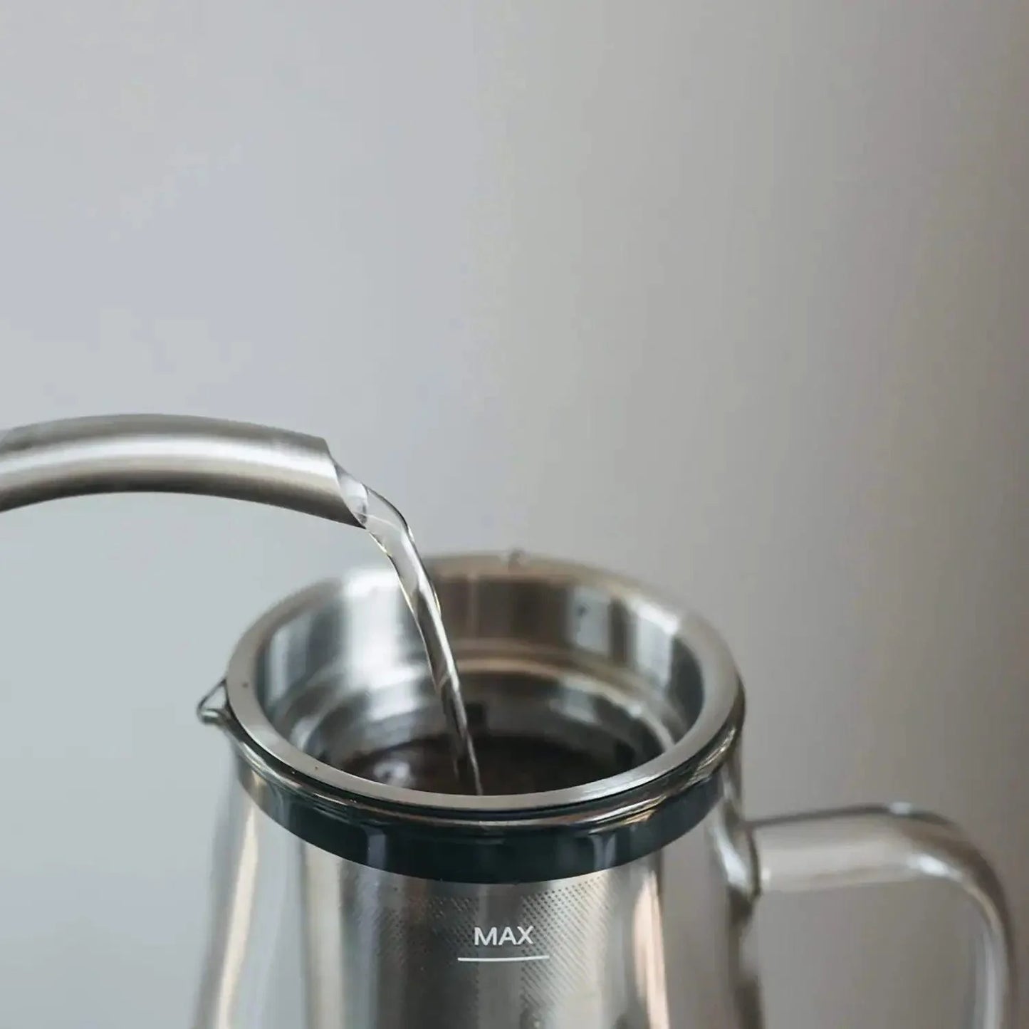 Ovalware Cold Brew Maker with glass jug, stainless steel filter, and black lid for making cold brew coffee at home.
