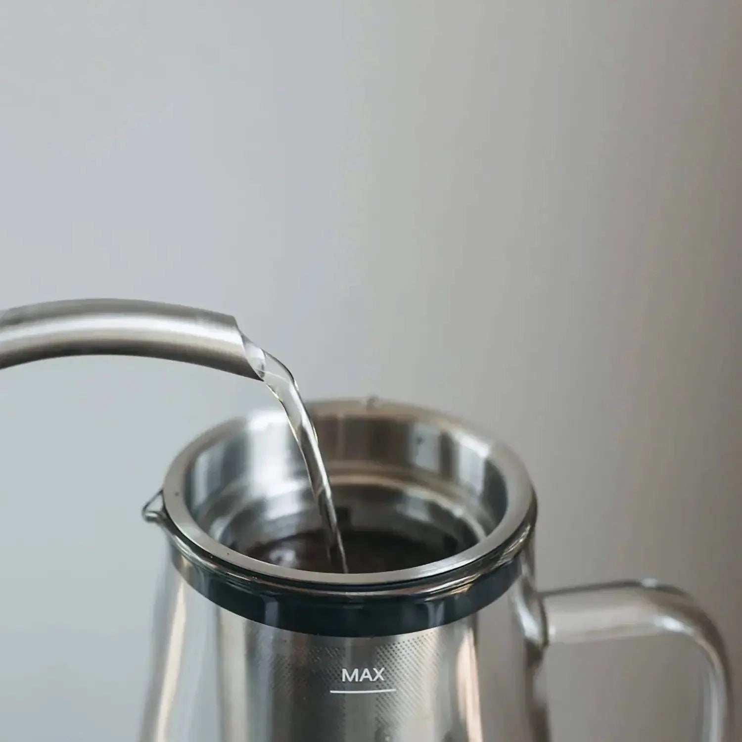 Ovalware Cold Brew Maker with glass jug, stainless steel filter, and black lid for making cold brew coffee at home.