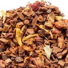 A steaming mug of Code 3 Rescue Coffee and Tea's Apple Cider Rooibos tea with fresh apple slices on top.